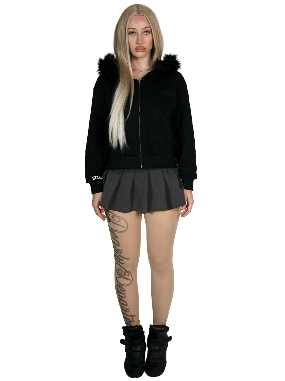 Person wearing a black hoodie with fur trim, black skirt, and black boots on a white background