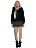 Person wearing a black hoodie with fur trim, black skirt, and black boots on a white background
