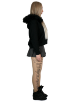 Person wearing a black hoodie with fur trim on a white background