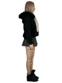 Person wearing a black hoodie with fur trim on a white background