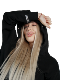 Person wearing a black hoodie with 'STARLIT' branding on a white background
