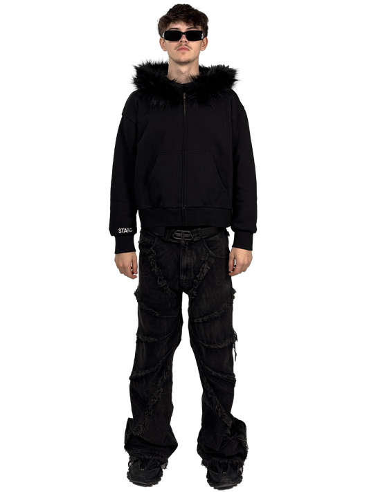 Front view of a model wearing a Starlit black fur hoodie with fur, highlighting the luxurious fur details and contemporary streetwear style.