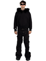 Front view of a model wearing a Starlit black fur hoodie with fur, highlighting the luxurious fur details and contemporary streetwear style.