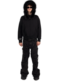 Front view of a model wearing a Starlit fur hoodie with fur and hood on, highlighting the luxurious fur details and contemporary streetwear style.