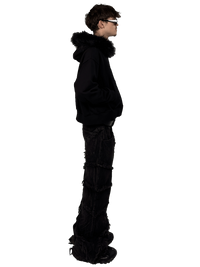 Side view of a model wearing a Starlit fur hoodie with fur, highlighting the luxurious fur details and contemporary streetwear style.