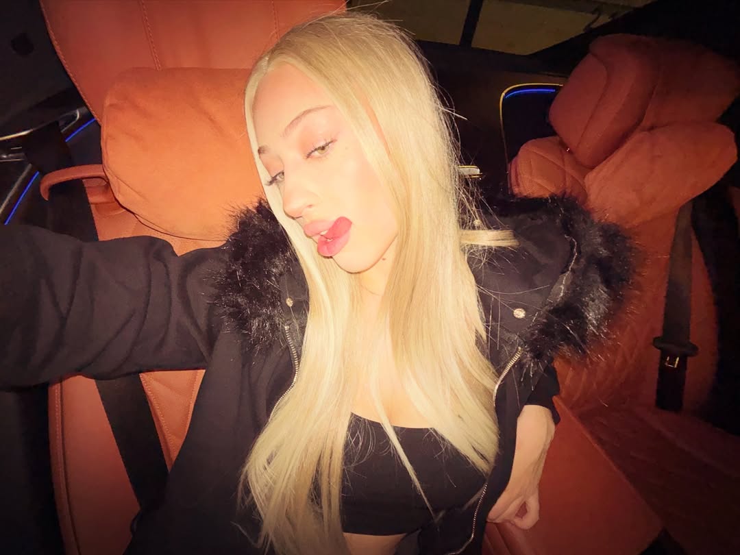 Model in Fur-Zip Hoodie, Sitting in Car, Dark Interior