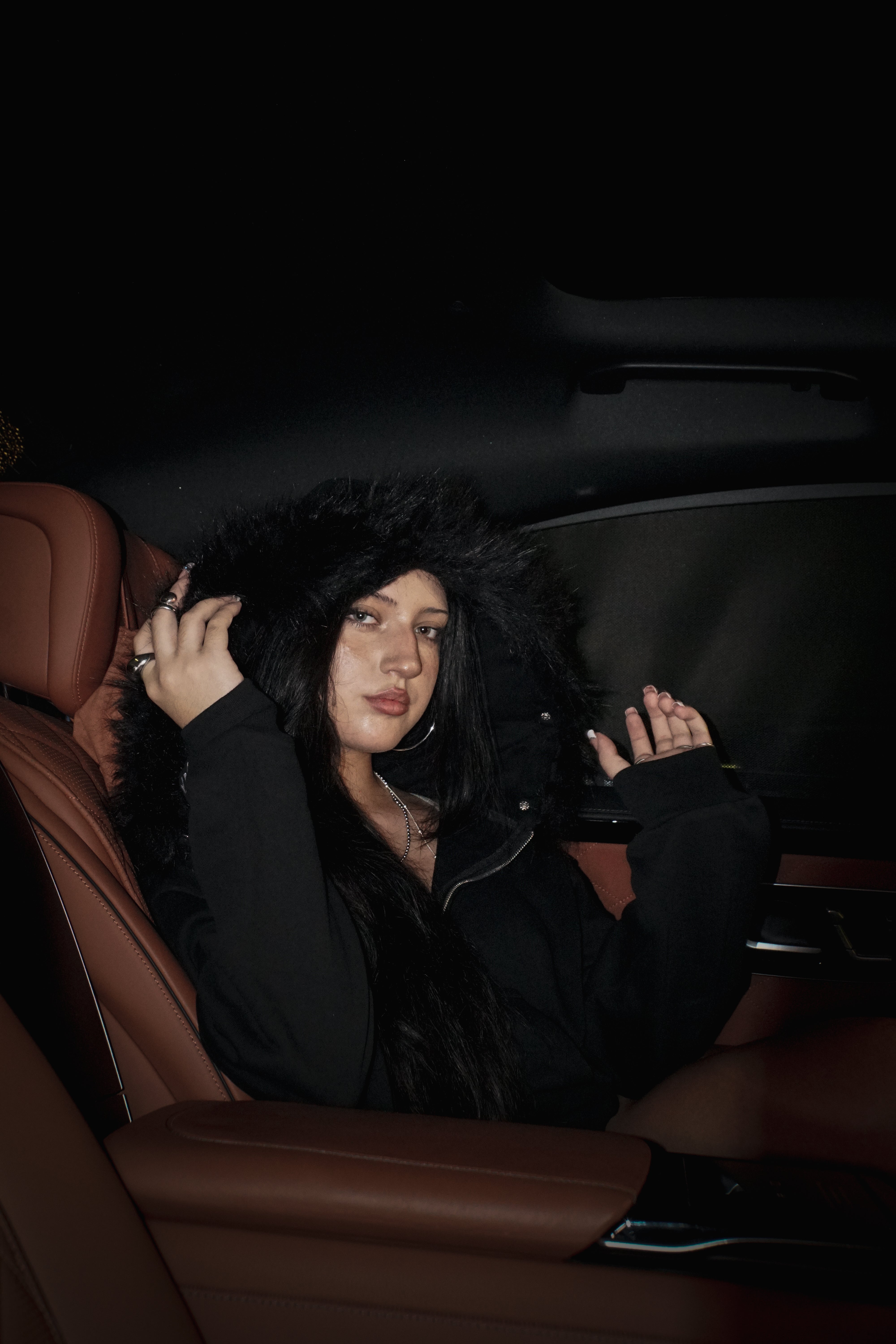 Woman sitting in a car with brown leather interior